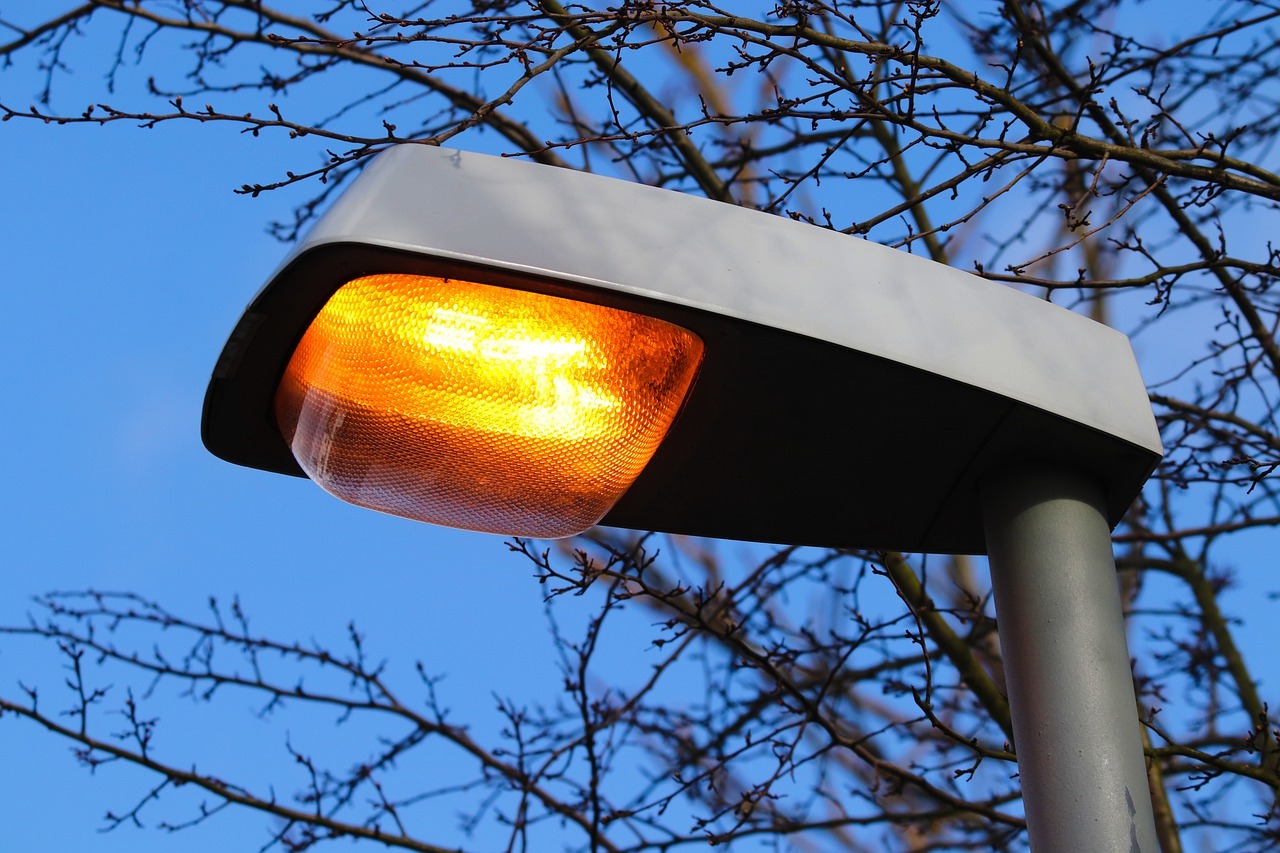 Close-up of a lit LED street-light head against a dark sky.
